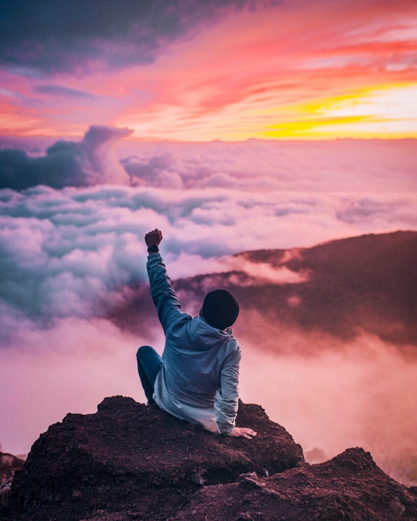 ian-stauffer-bH7kZ0yazB0-unsplash A man sitting on the mountain in joy